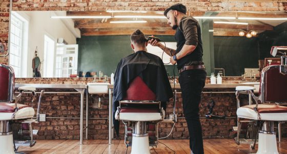 Barber cutting a mans hair in the barbers chair