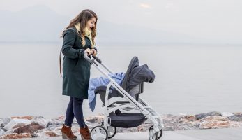 Mother pushing her baby in a pram