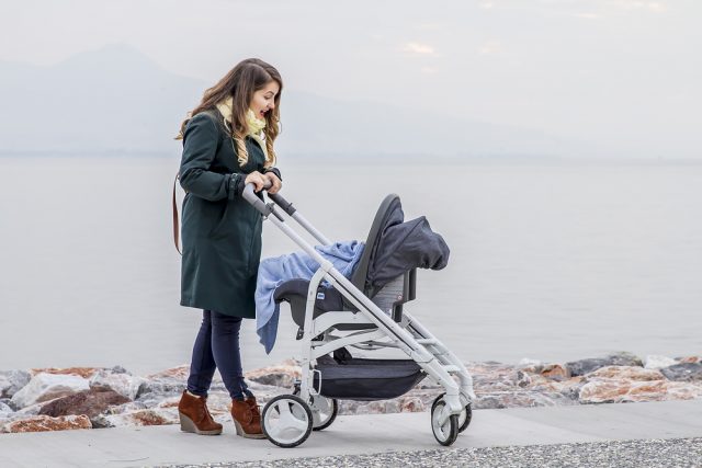 Mother pushing her baby in a pram