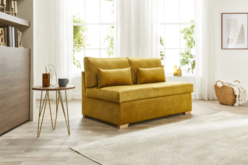 Sofabed.co.uk mustard yellow sofa in room with natural light coming through windows behind