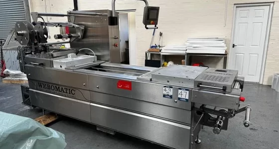 First Food Machinery warehouse with large food processing machine